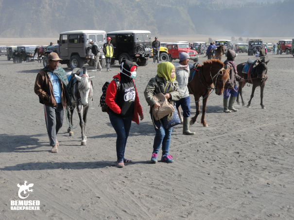 Tourists riding horses on the sea of sand Mount Bromo Indonesia